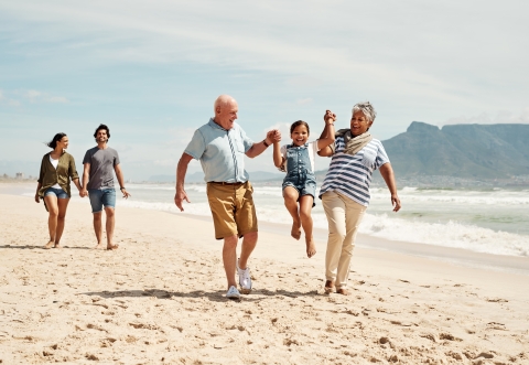 Happy family 3 generations on a beach