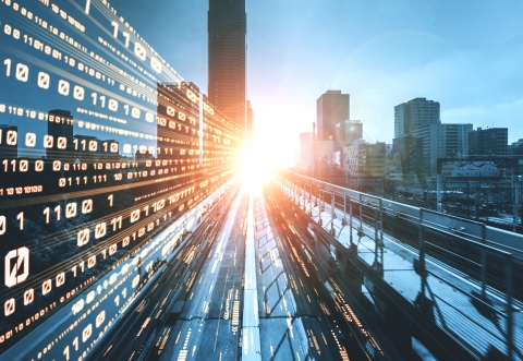 Highway with high walls of stock market figures pointing to a distant horizon where the sun is shining